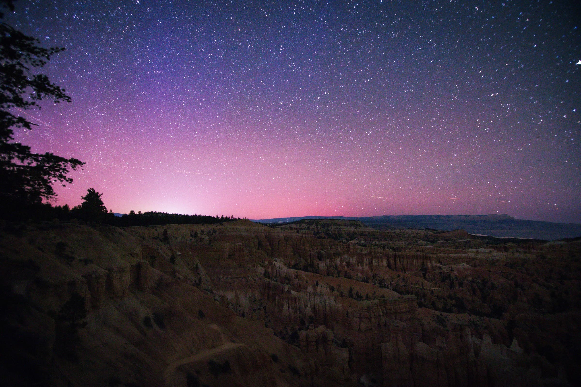 Last light over the Bryce Canyon rim, magenta and violet above the hoodoos
