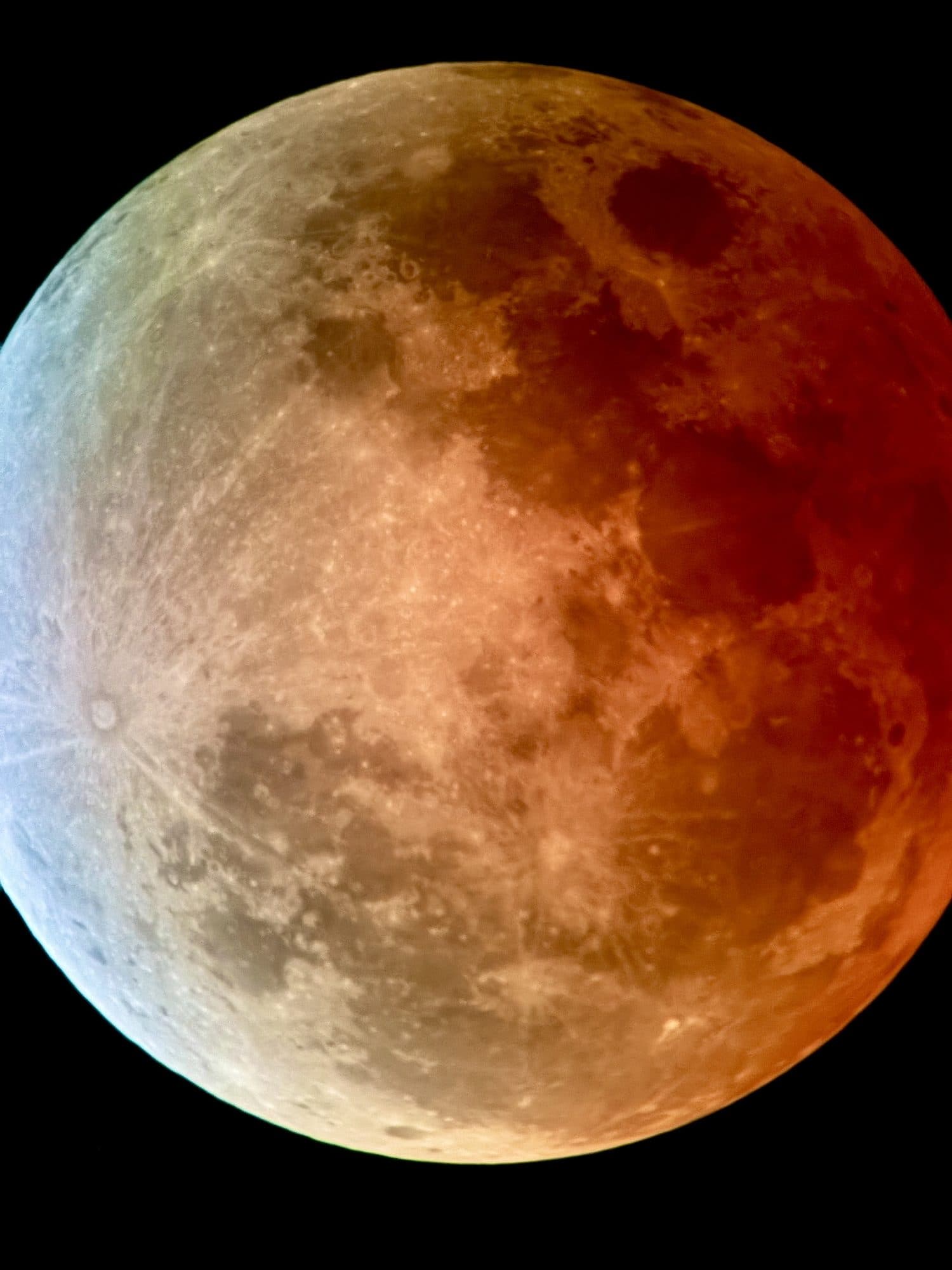 The moon deep in Earth's shadow, most of the disk turned copper red