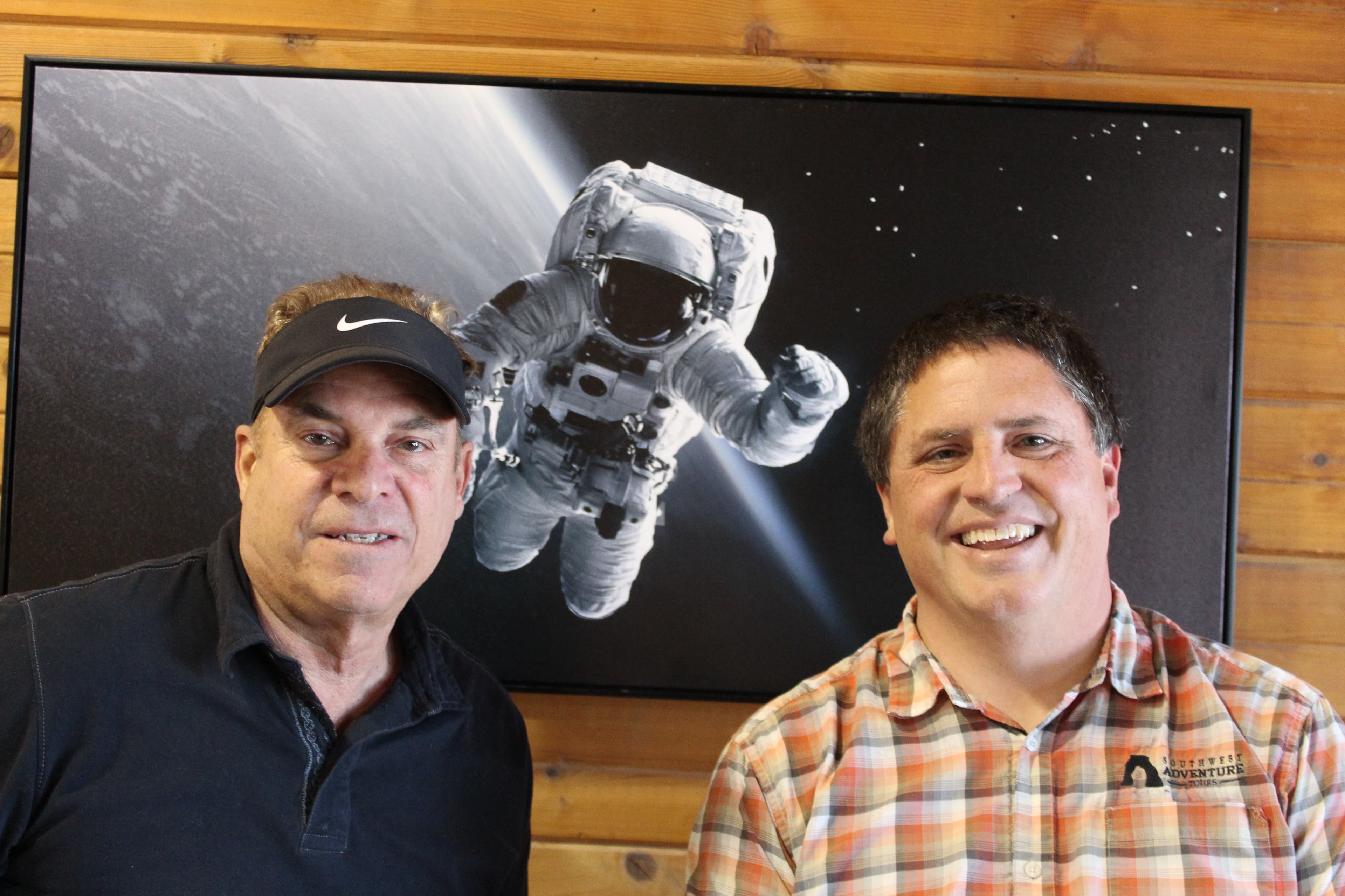 Richard and Jason, founders of Bryce Canyon Stargazing, in front of an astronaut mural