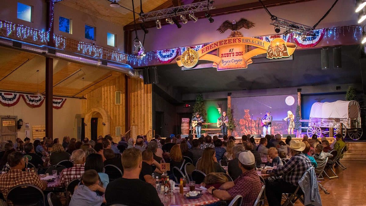 Guests at a Western dinner show inside Ebenezer's Barn and Grill